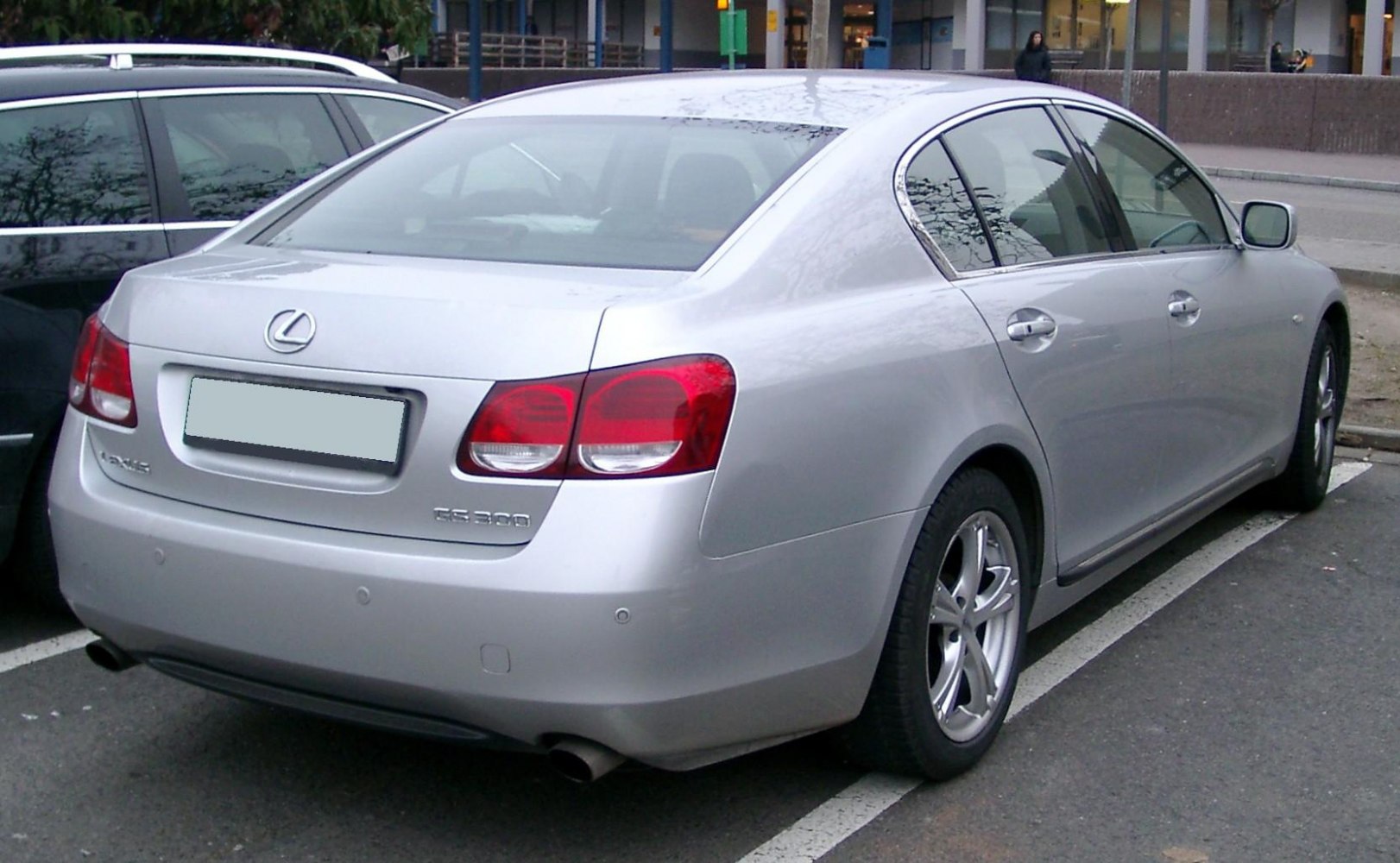 Rear view of sedan with dual exhaust and distinctive tail lights