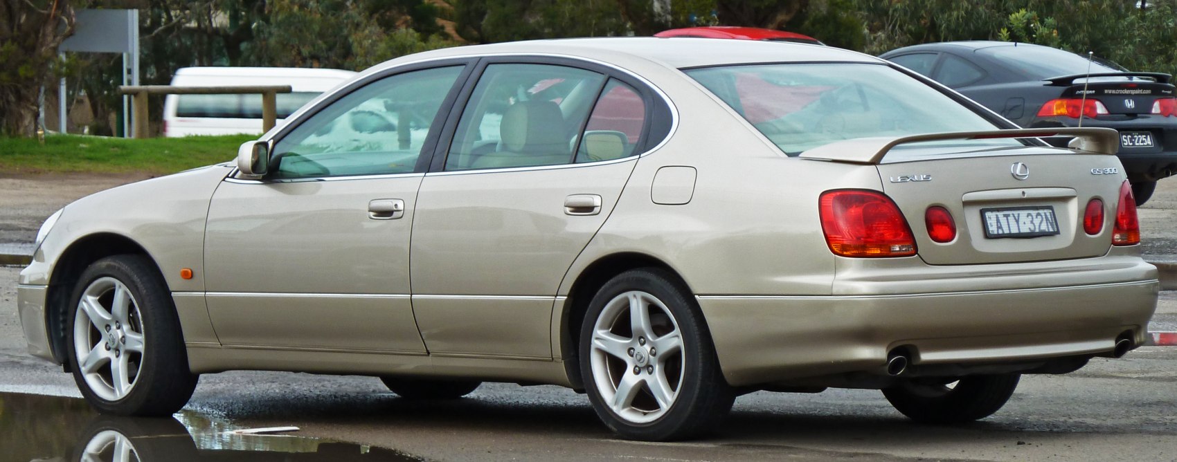 Silver luxury sedan rear side with alloy wheels and spoiler