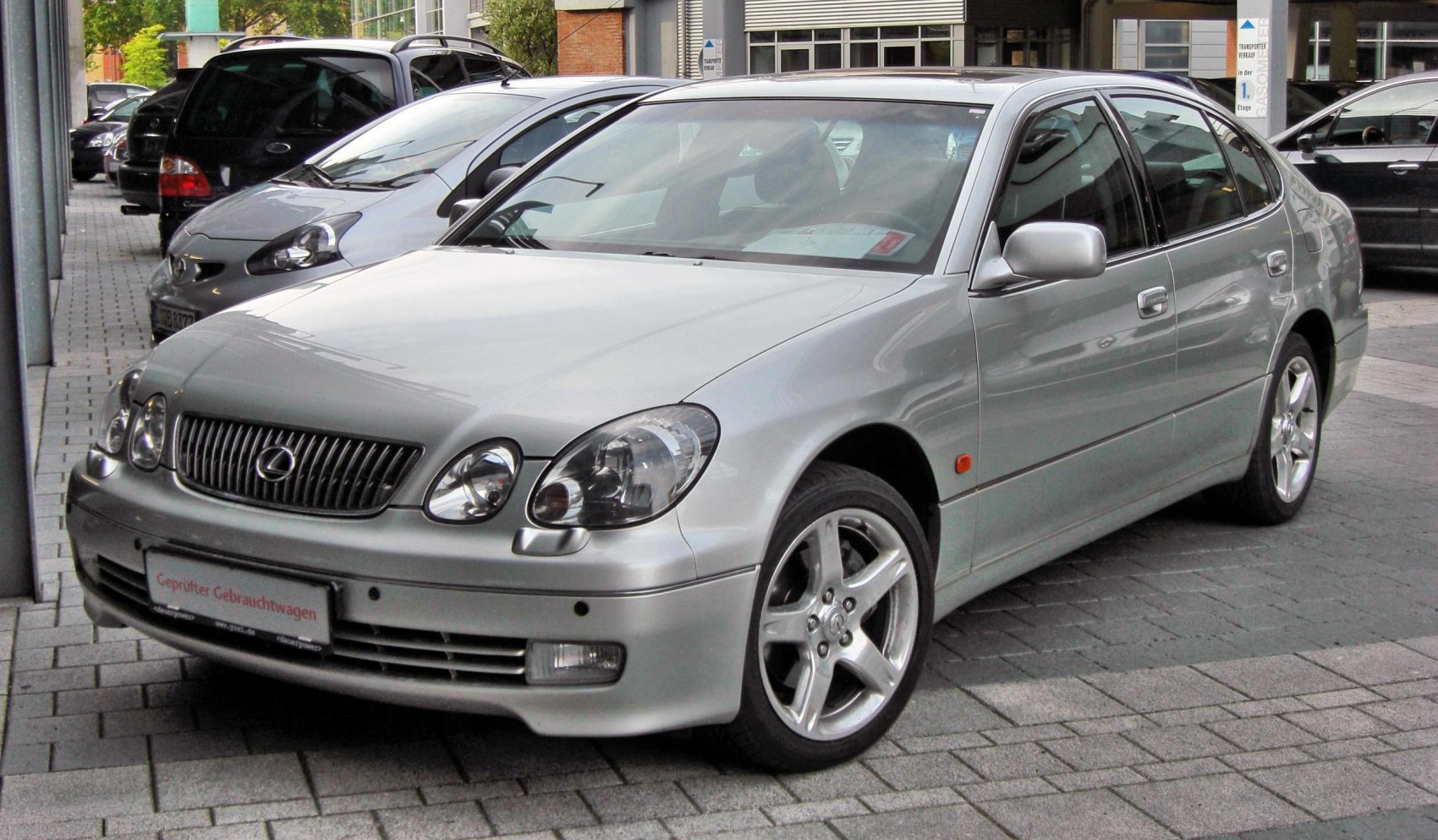 Front view of silver sedan with rounded headlights and five-spoke alloy wheels