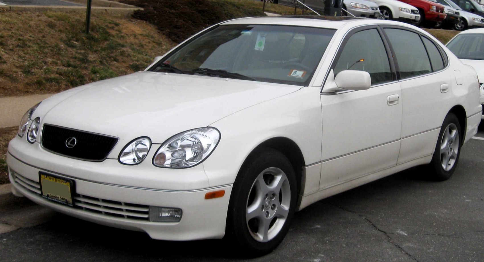 White sedan with rounded headlights and alloy wheels.
