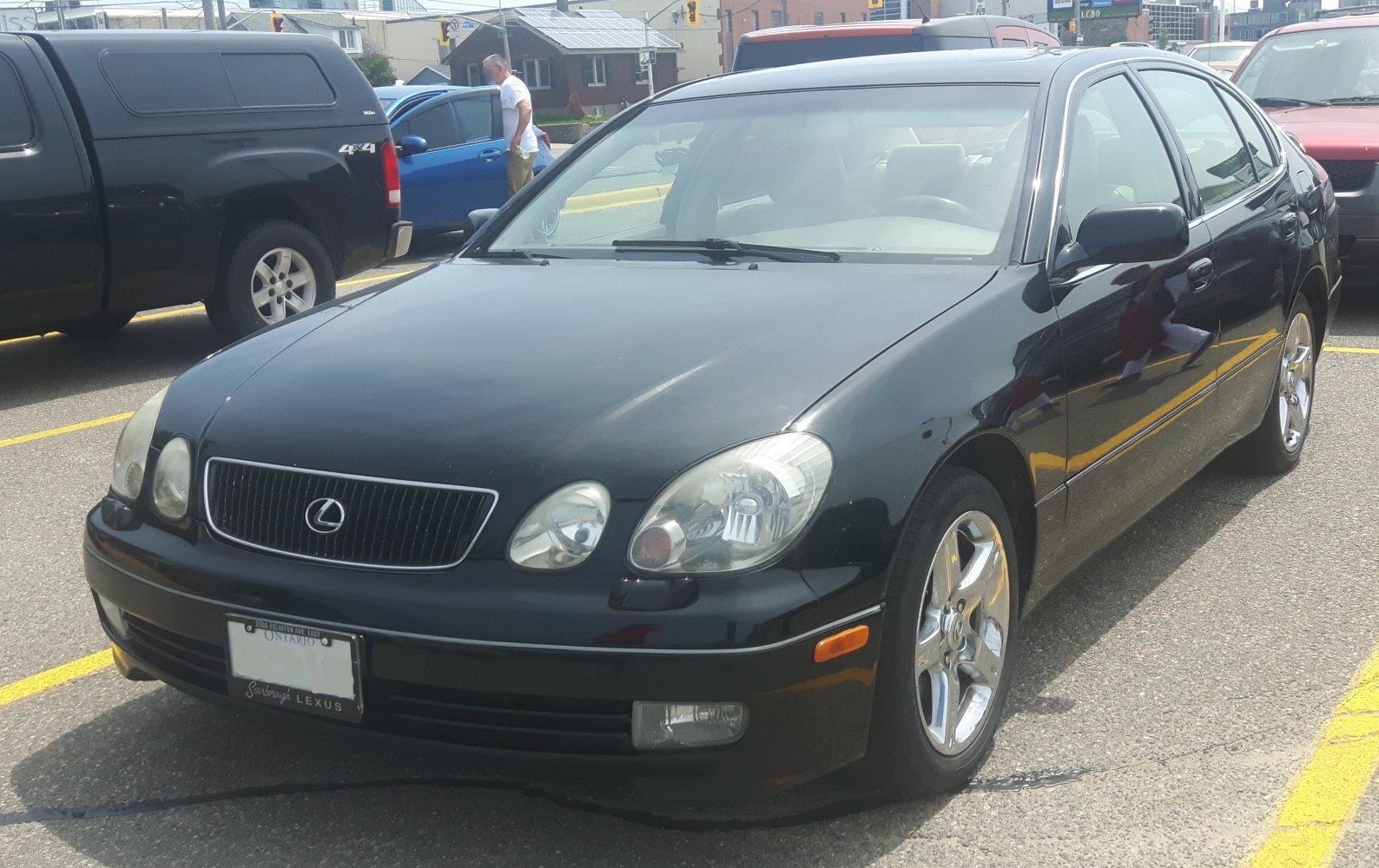 Black sedan with chrome wheels and dual round headlights