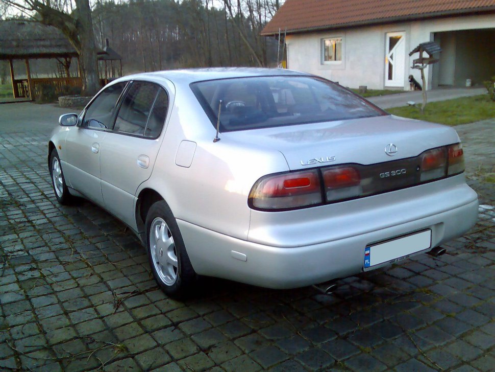 Rear view of a 1993 sedan with distinct taillights and trunk design.