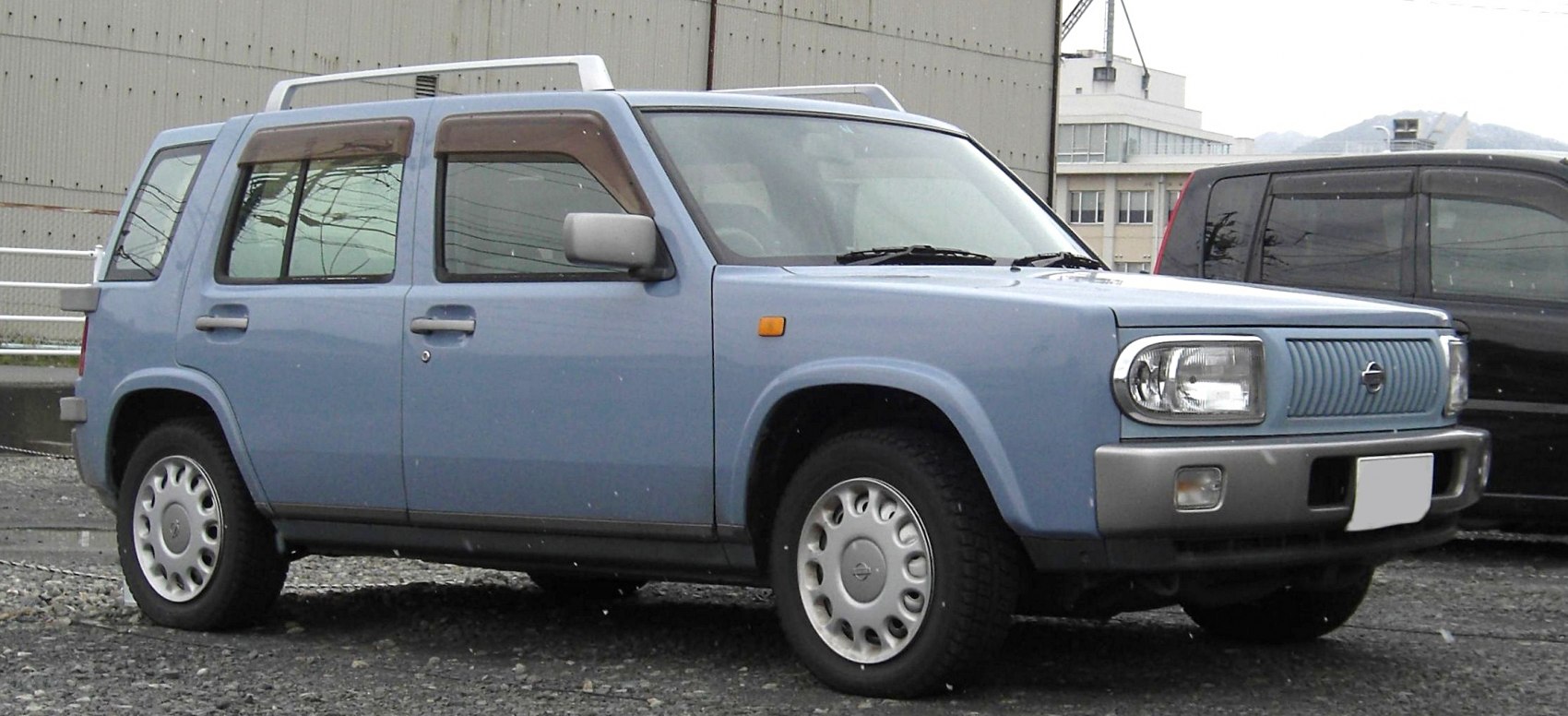 Boxy retro side profile of compact four-door SUV with distinctive grille