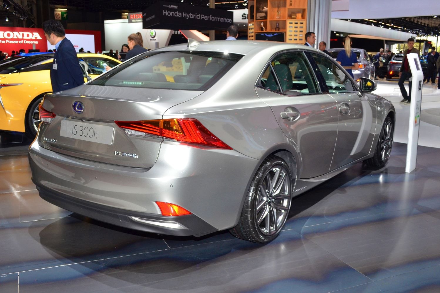 Rear side view of a silver sedan with sharp tail lights and alloy wheels.