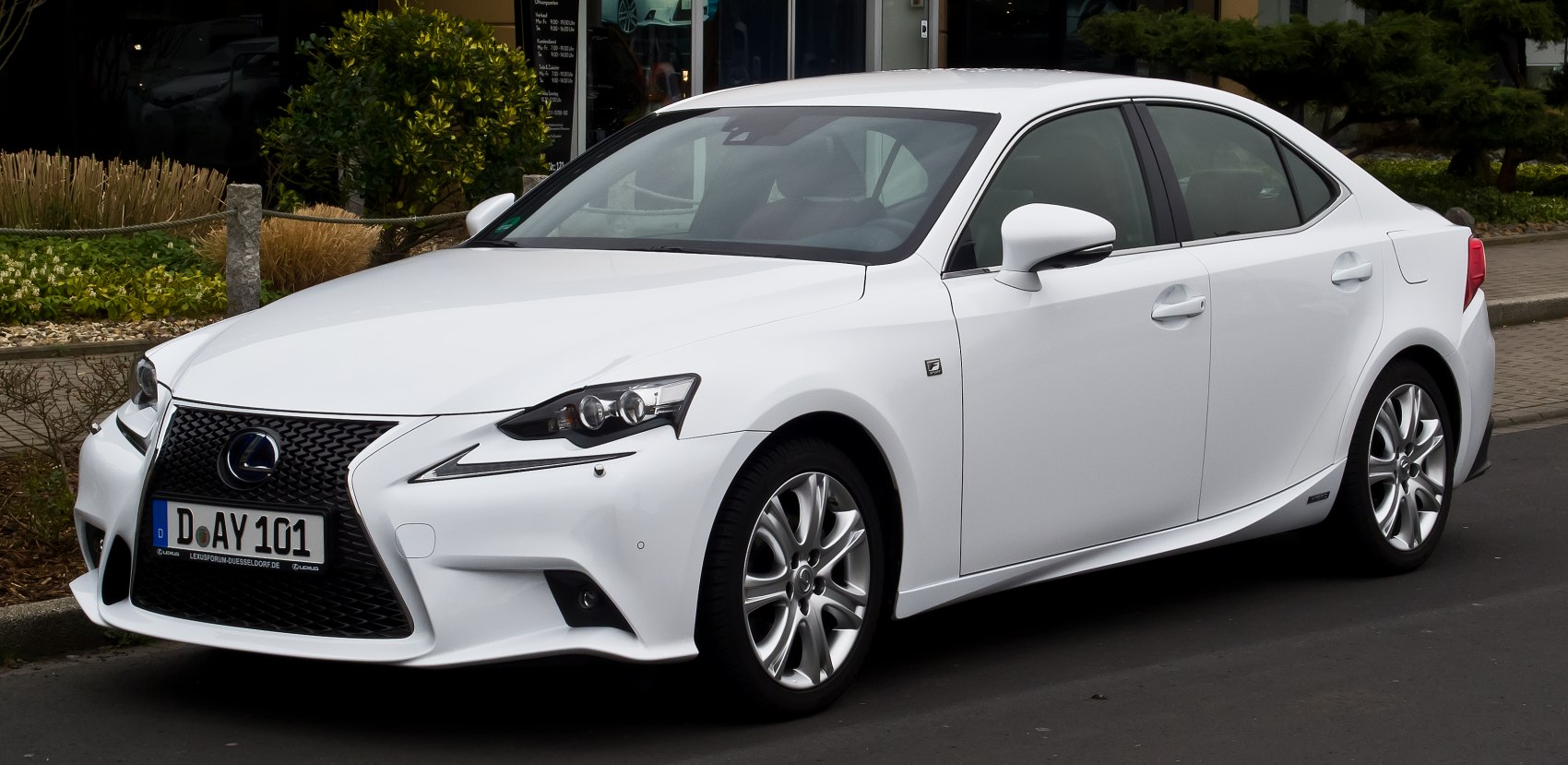 Luxury sedan front-side with spindle grille and sharp LED headlights