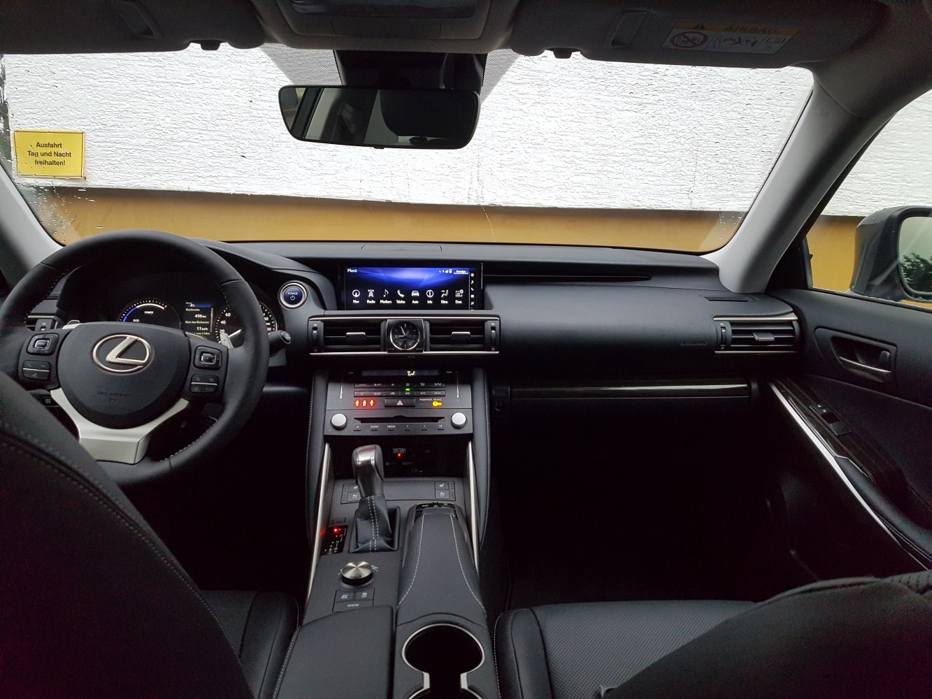 Dashboard, steering wheel, infotainment screen, and center console view