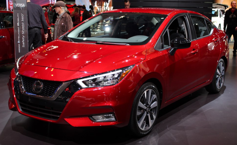 Front-side view with LED headlights and alloy wheels on red sedan