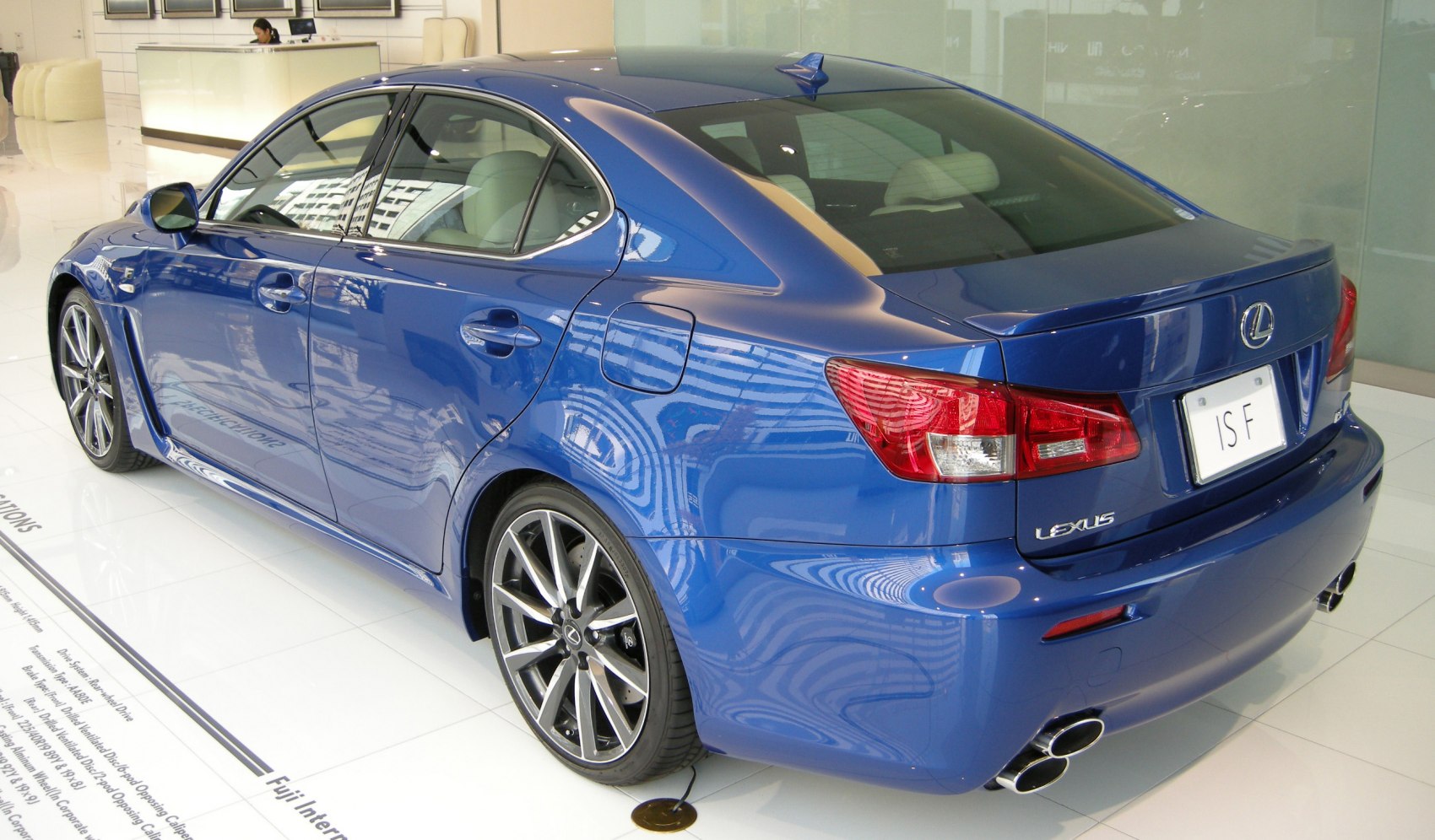 Blue sedan with sporty wheels and quad exhaust tips