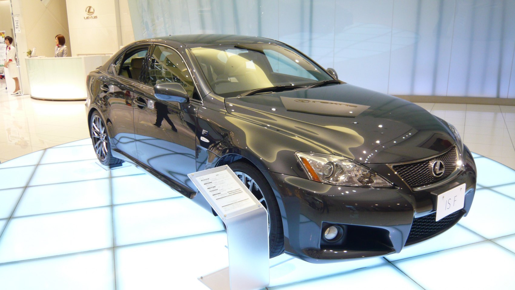 Sporty front fascia and sleek aerodynamic luxury sedan on showroom floor