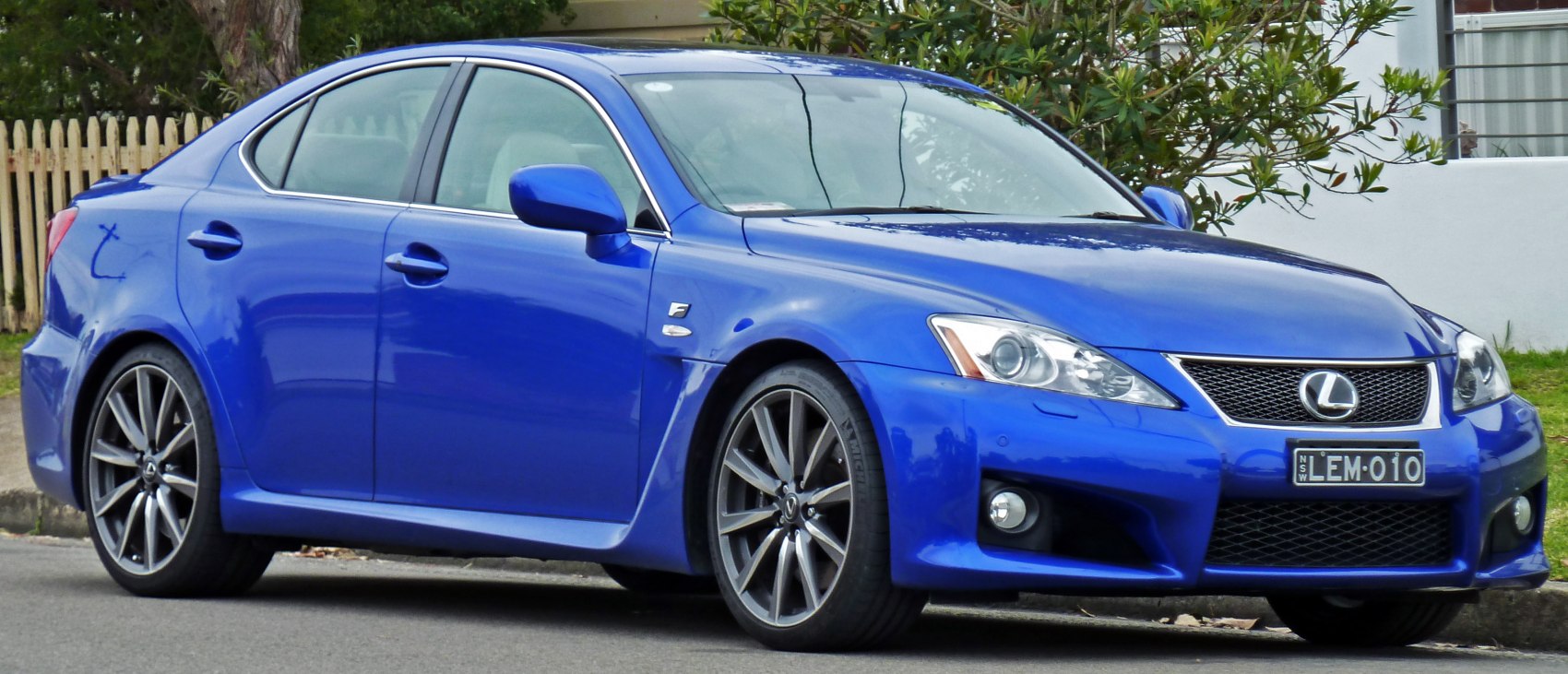 Blue sports sedan with sharp headlights and alloy wheels