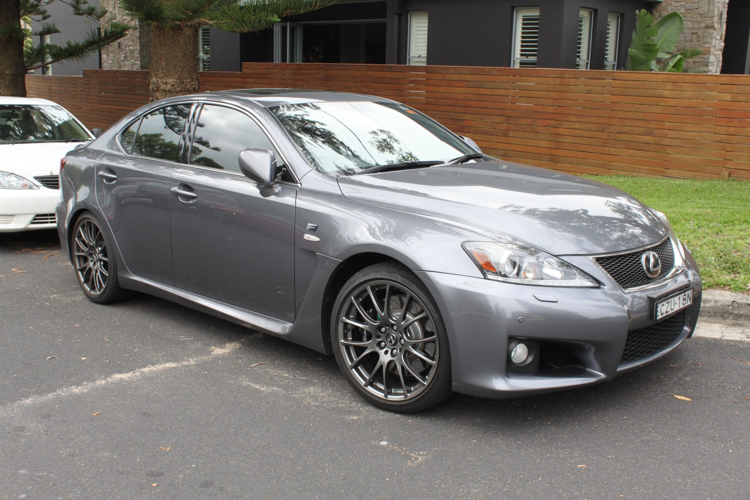 Sleek sedan front side with sporty alloy wheels