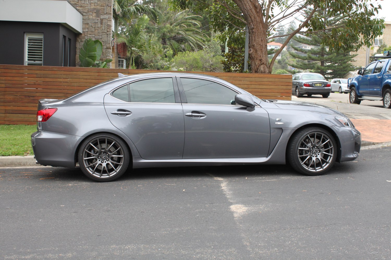 Sleek gray sports sedan with aerodynamic side profile and multi-spoke alloy wheels.