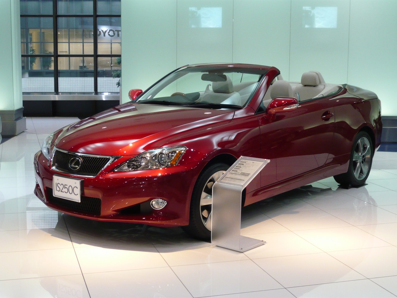 Red luxury convertible coupe with beige interior, sleek design and open roof