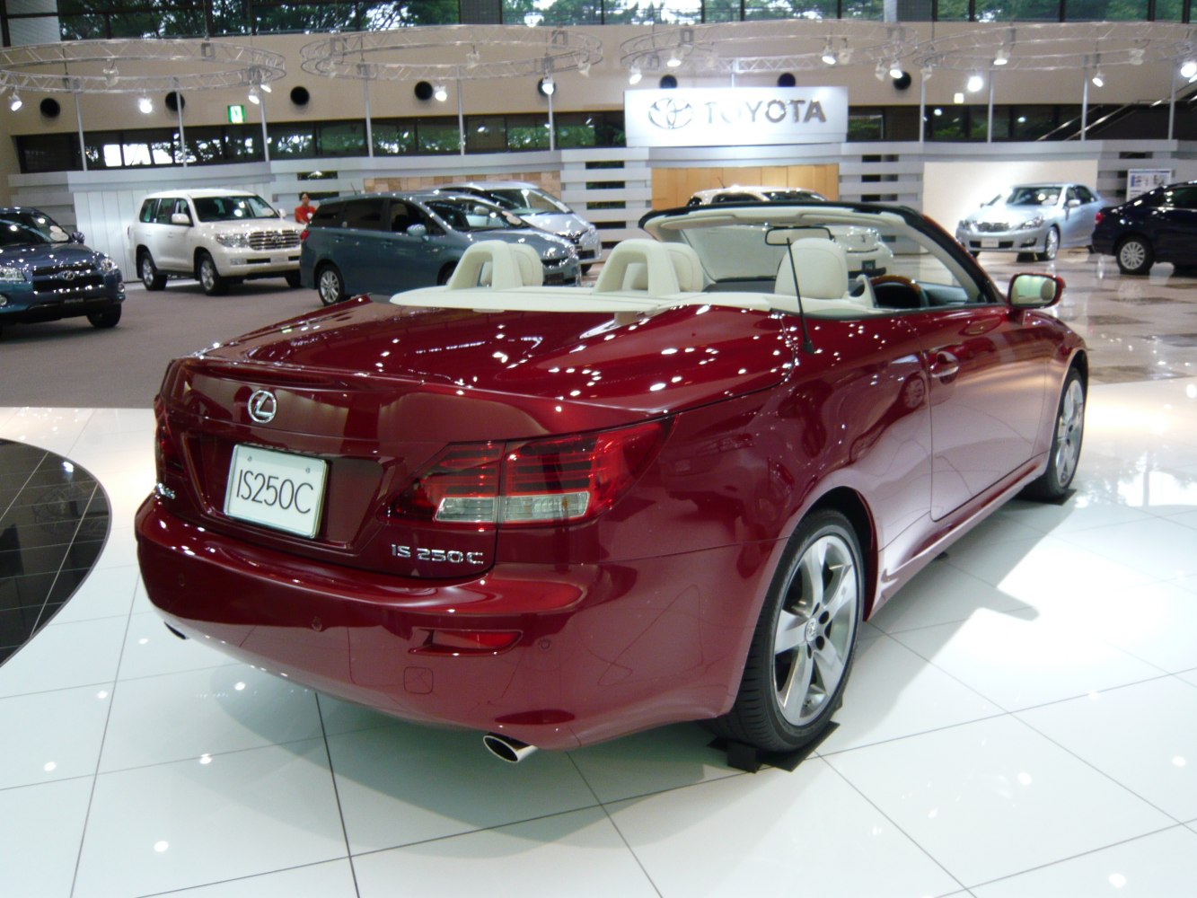 Rear view of a red convertible coupe with cream interior and dual exhaust