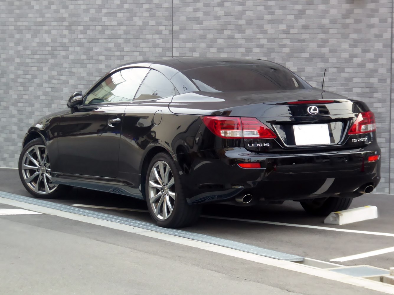 Luxury black sport coupe rear with alloy wheels and dual exhausts