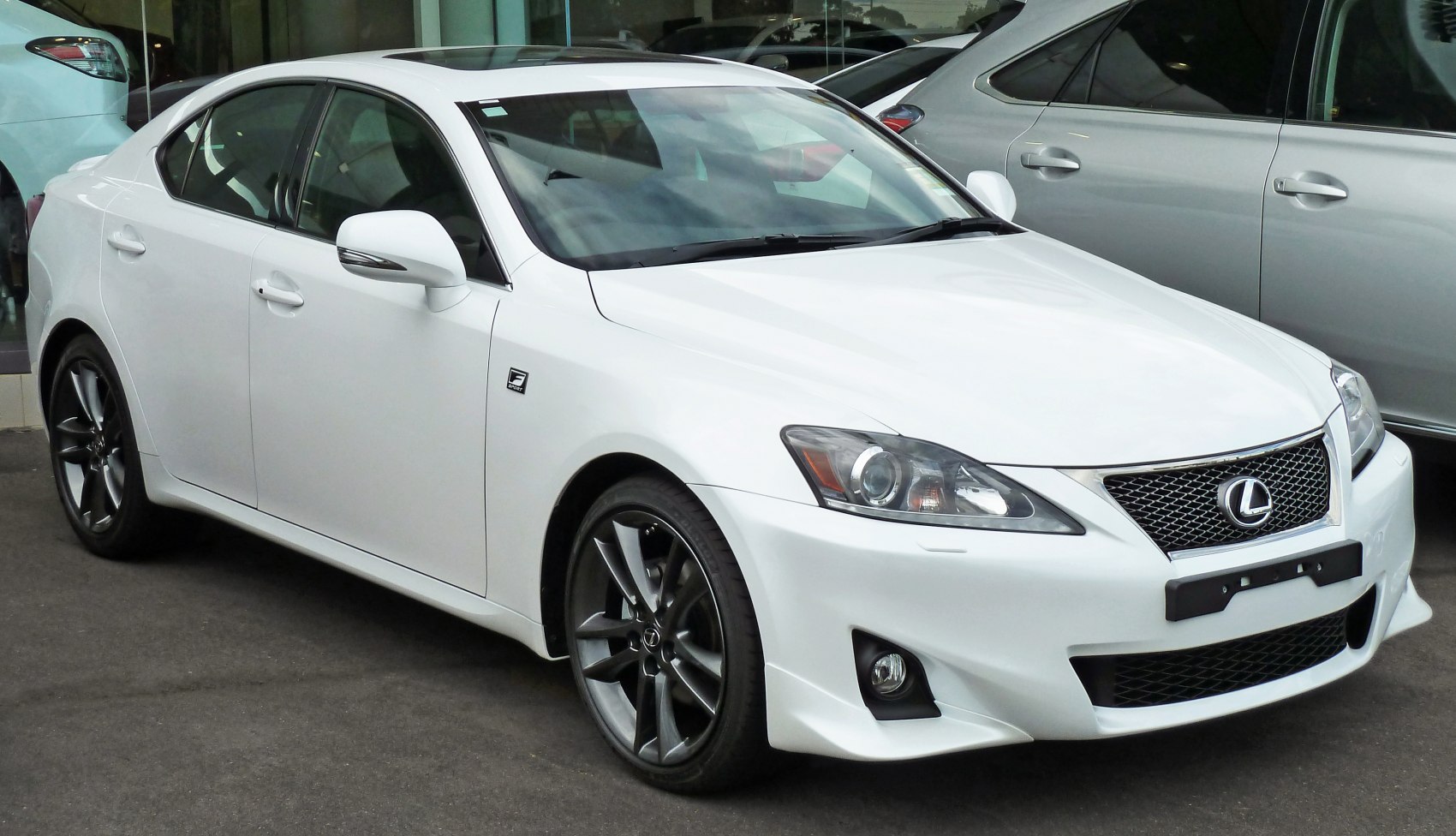 Front-side view of white luxury sedan with Lexus grille and sporty alloy wheels