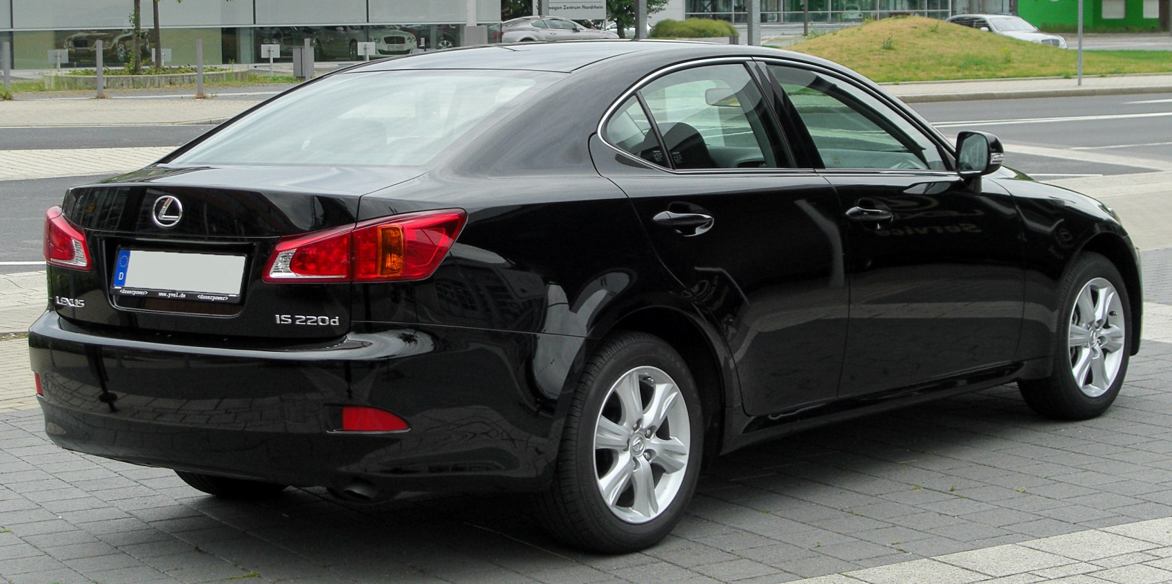 Rear side view of black sedan with distinct tail lights and alloy wheels