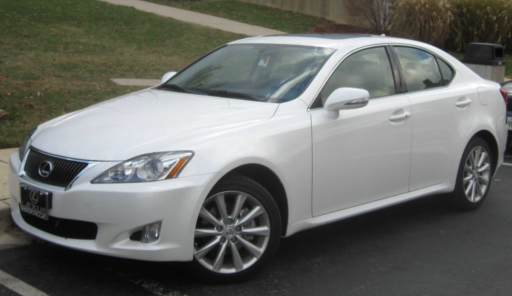White sedan with sleek headlights and alloy wheels, front-side angled view