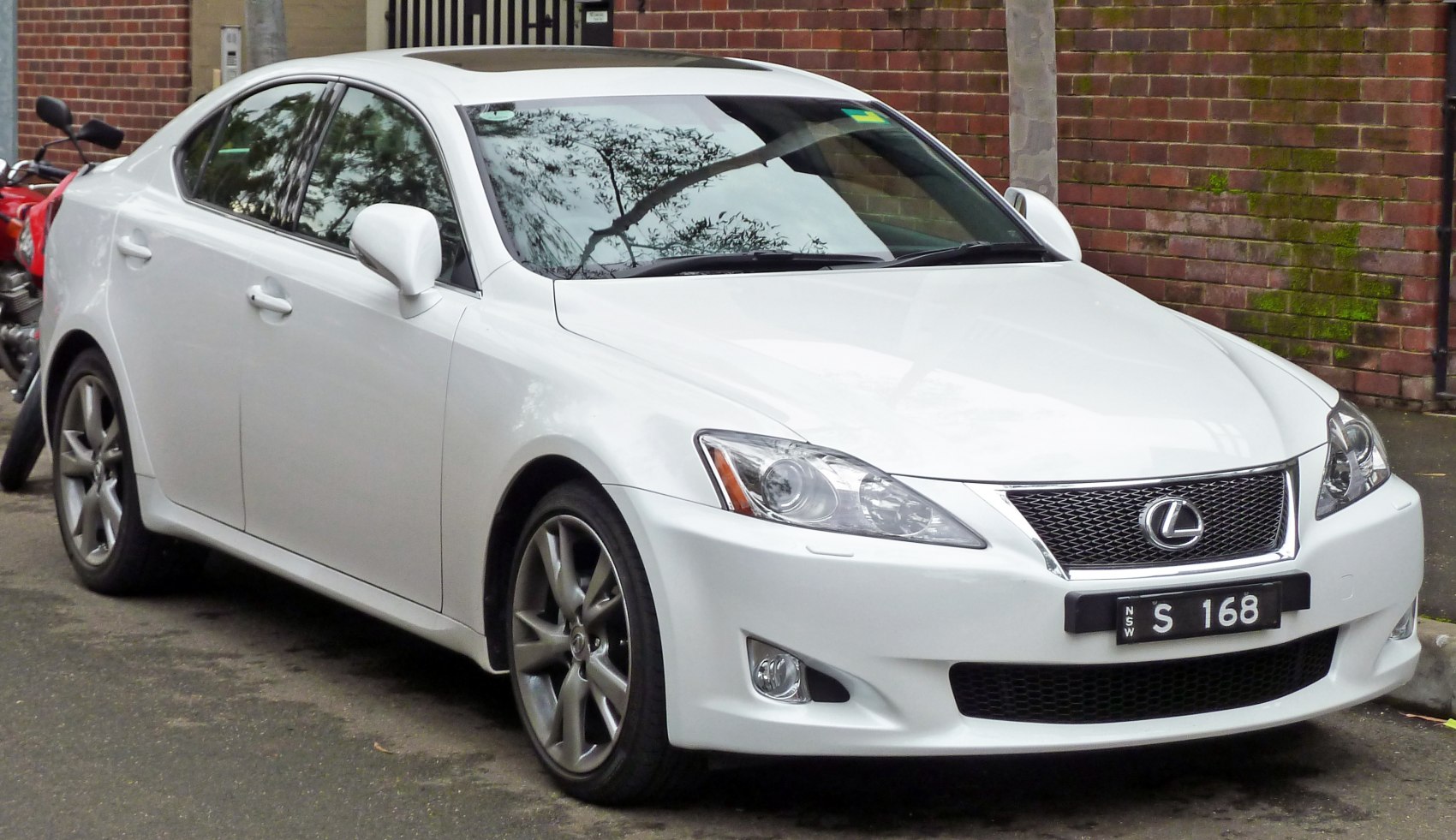 Front grille and headlights of a white sedan with sporty design