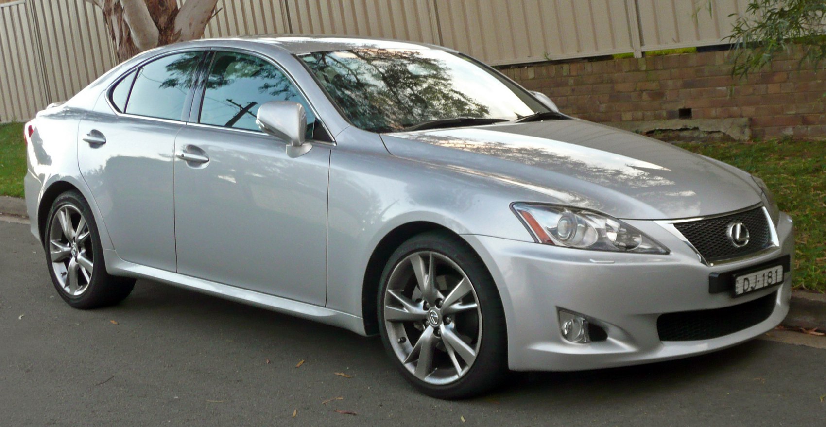 Silver sporty sedan with alloy wheels and sleek front design.