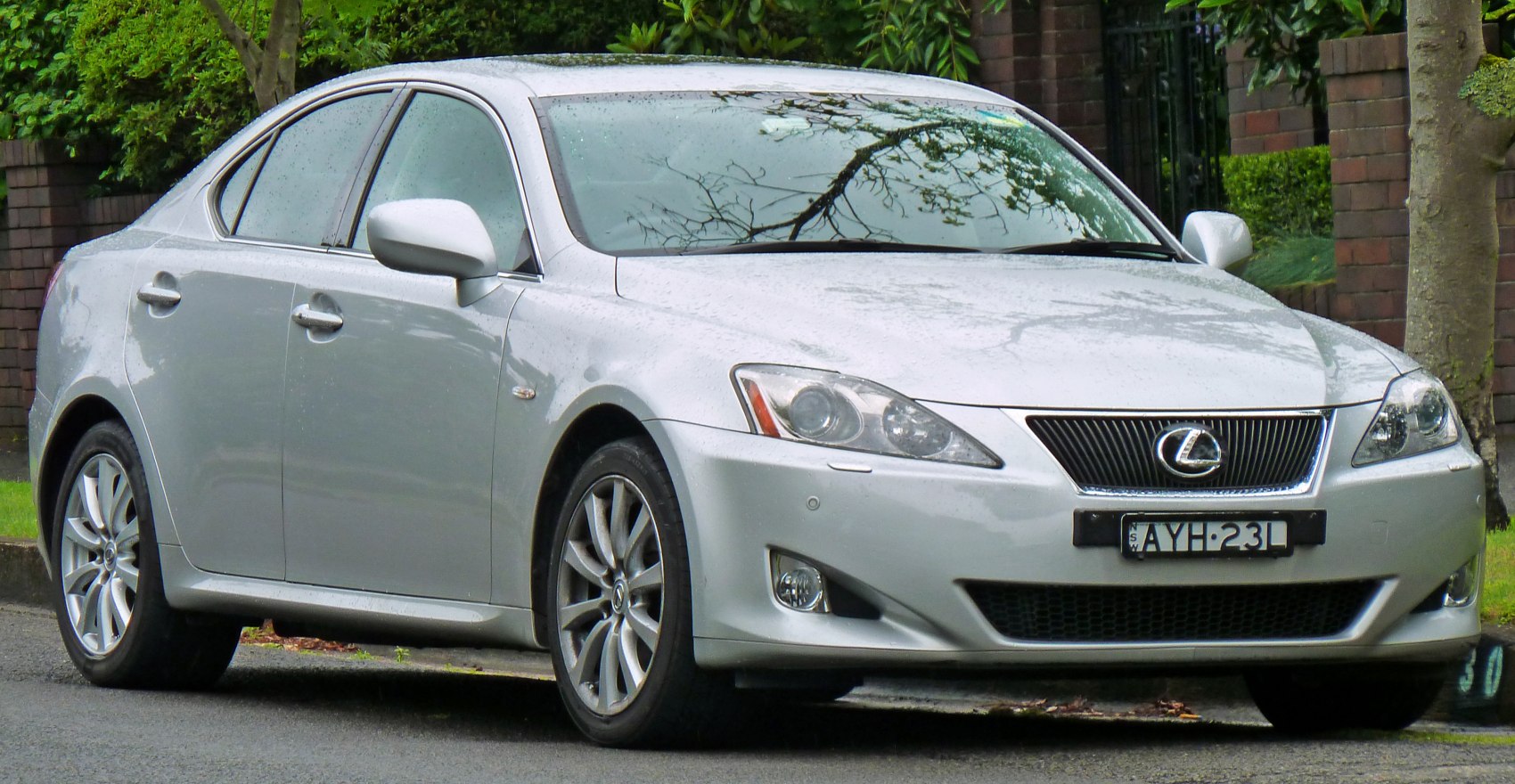 Silver luxury sports sedan with sleek headlights and alloy wheels, front side view
