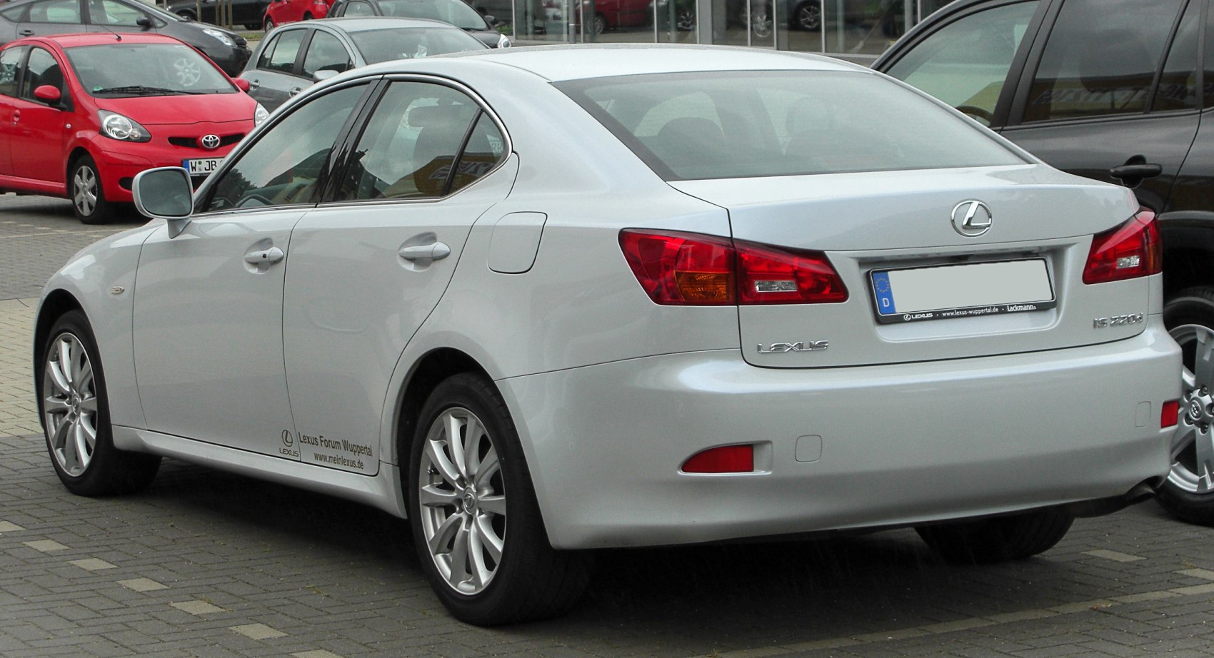 Rear view with taillights and alloy wheels of a four-door luxury sedan
