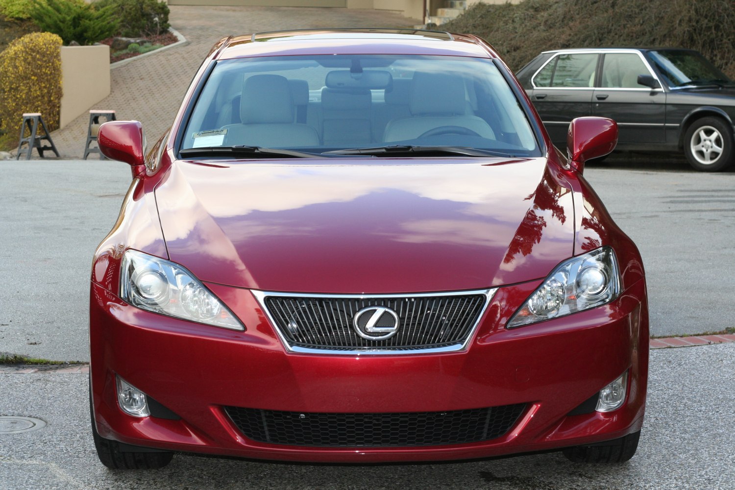 Front view of red sedan with distinctive grille and sharp headlights