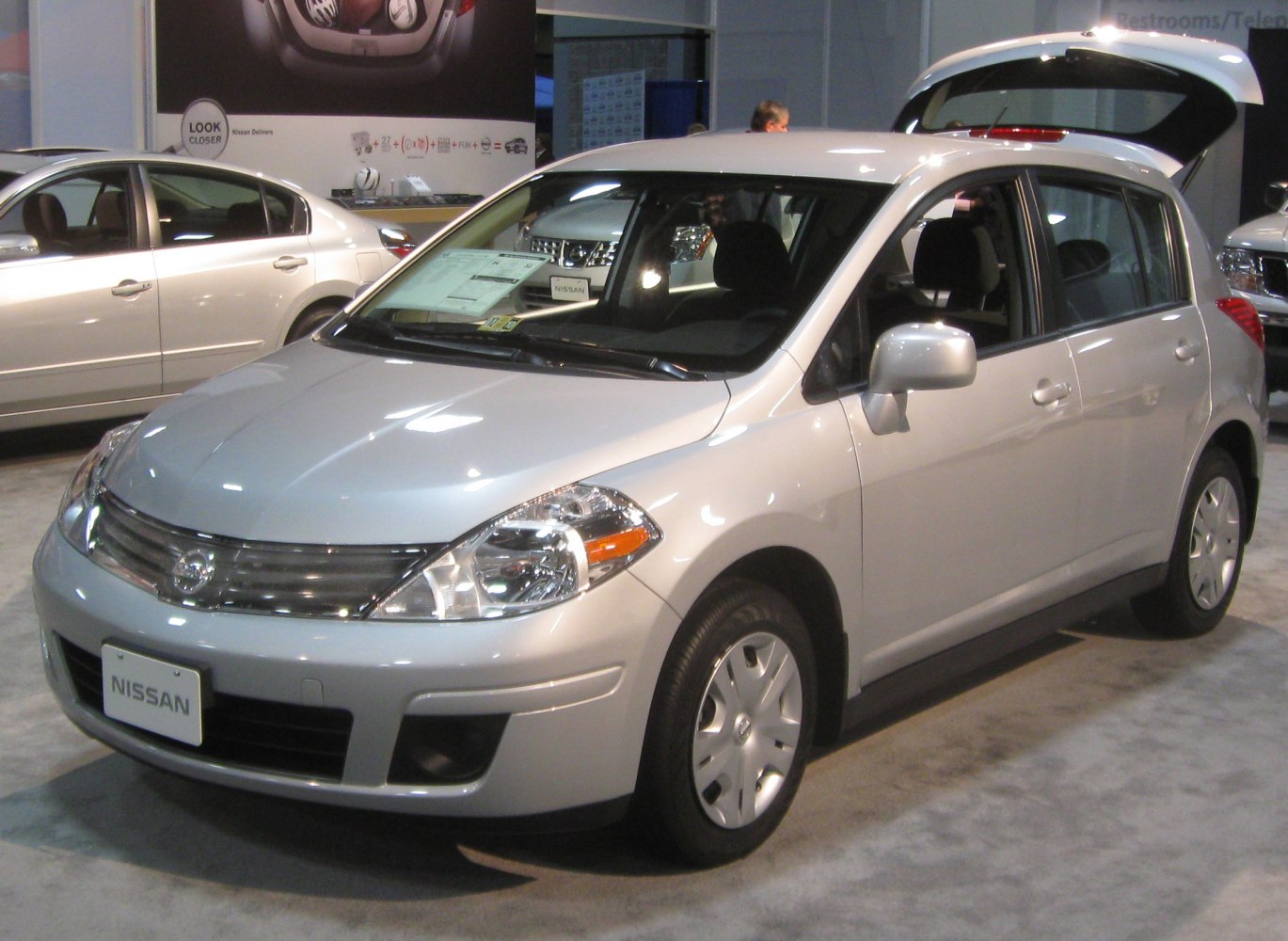 Front side view of a hatchback with open rear hatch