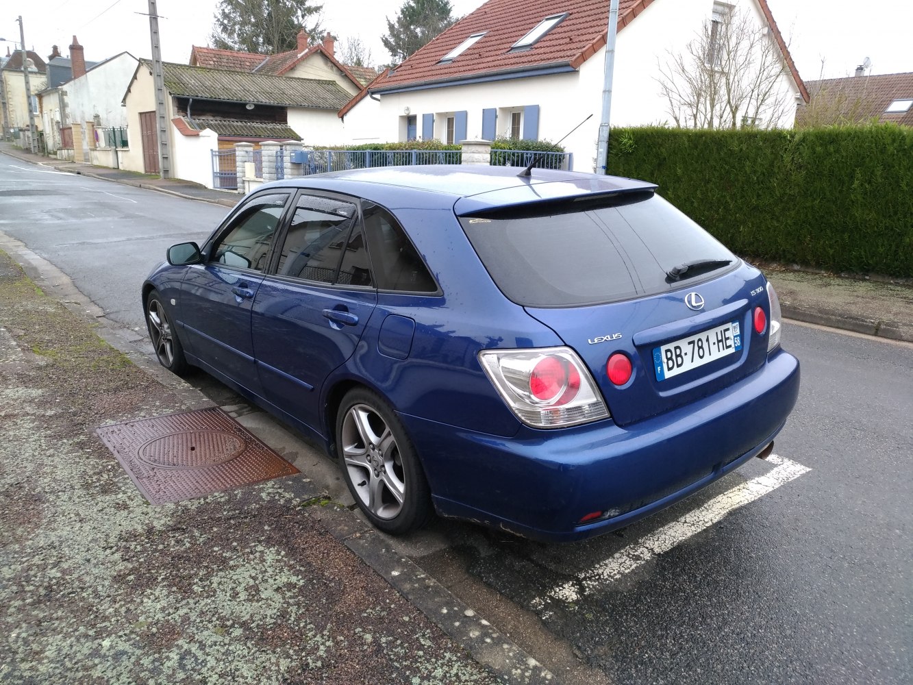 Rear-side view of station wagon with hatchback and alloy wheels