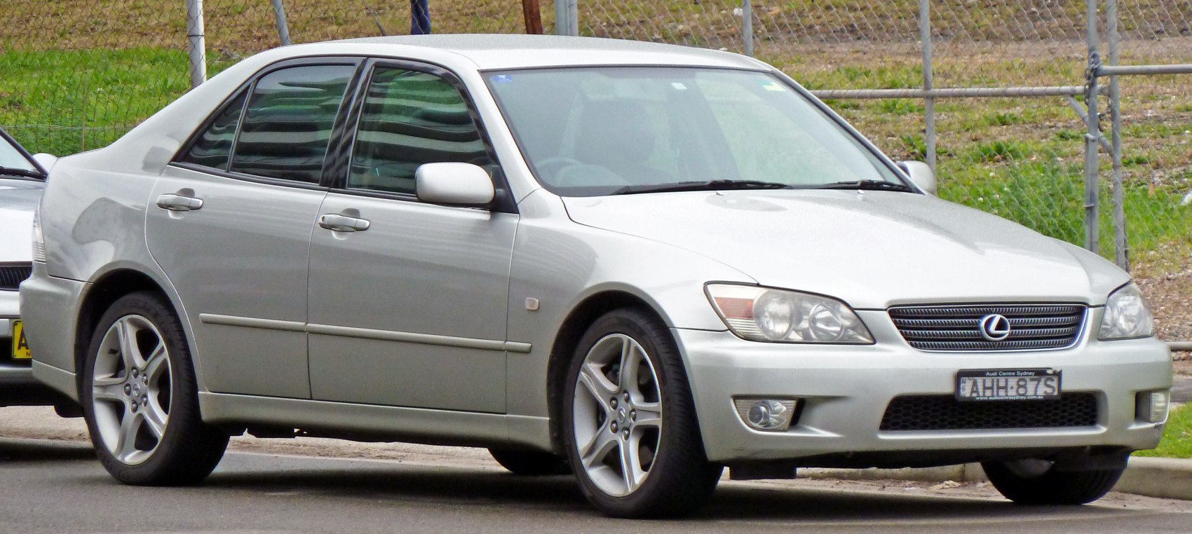 Silver sedan front side view with alloy wheels and headlights