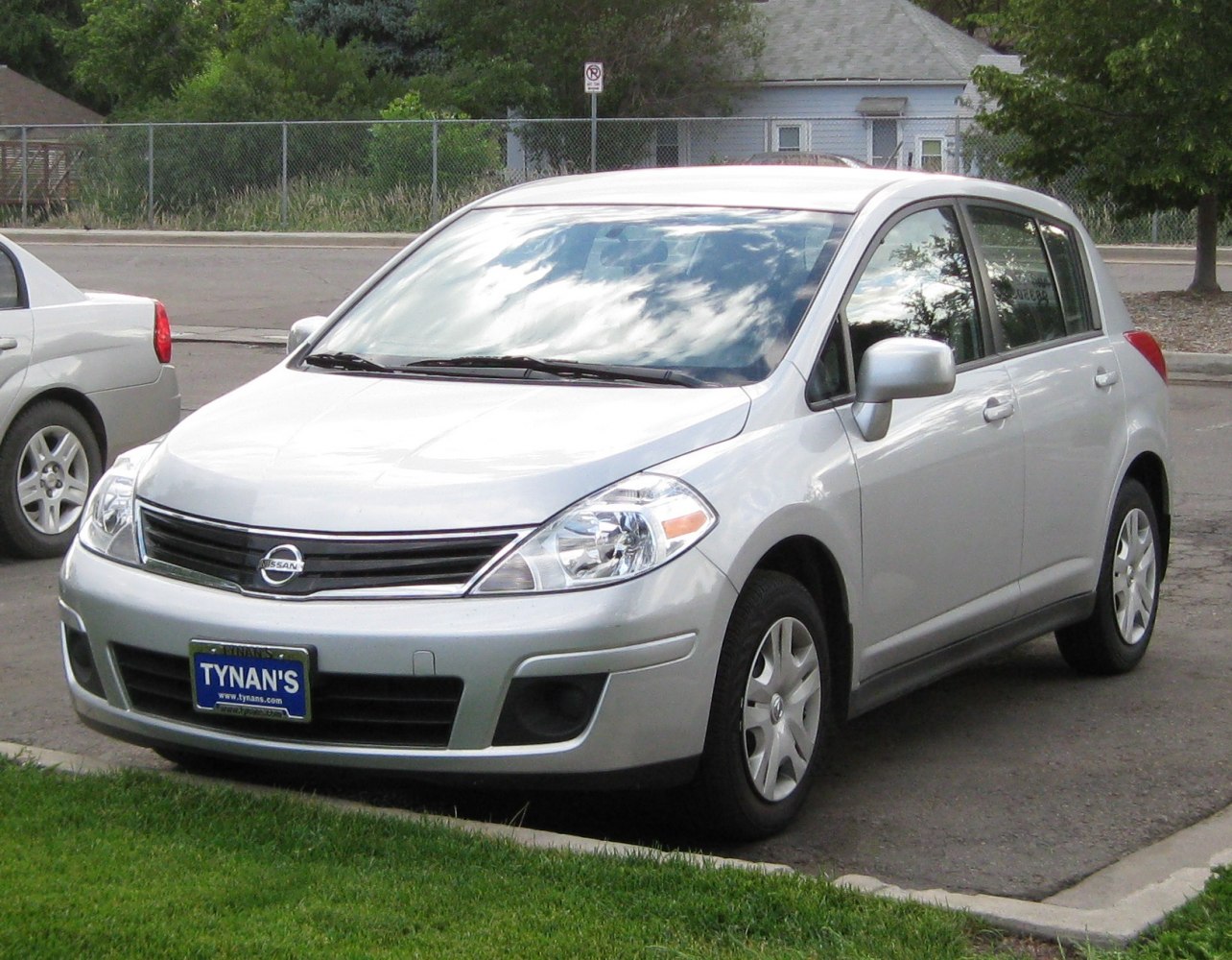 Compact hatchback with rounded headlights and black grille