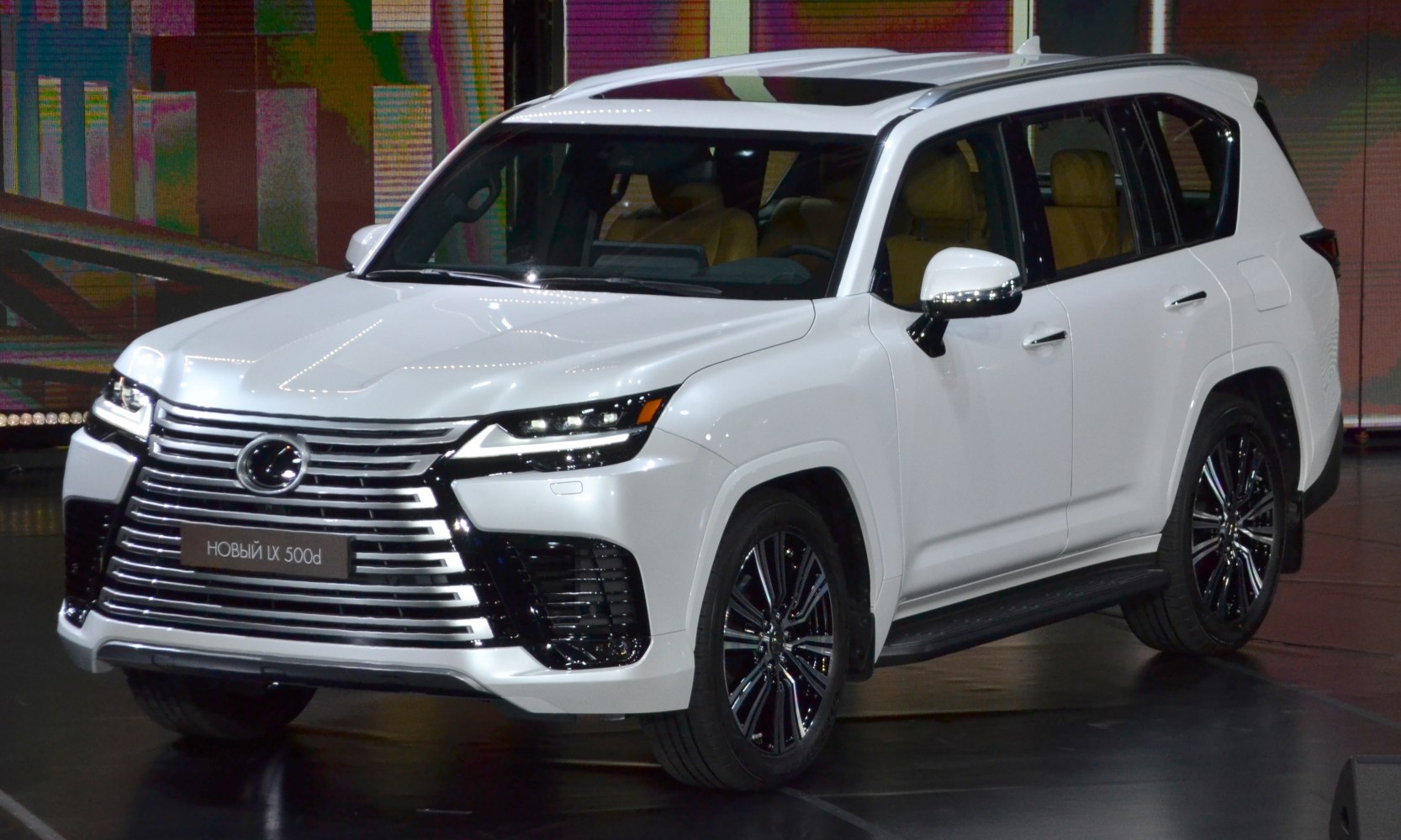 White luxury SUV with modern grille and LED headlights