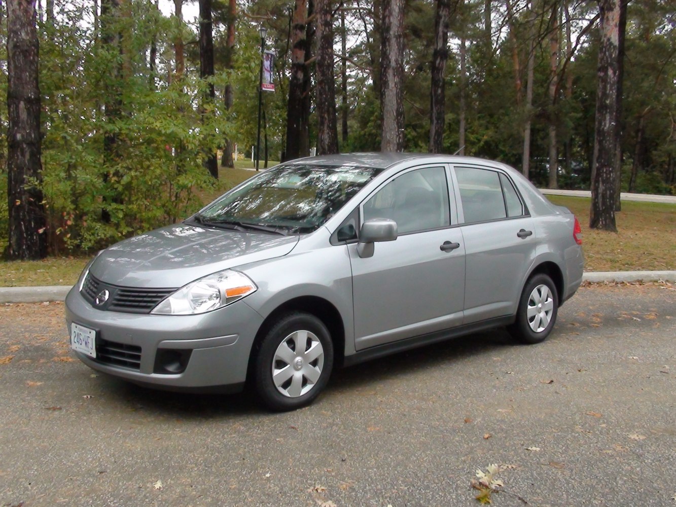 Silver compact sedan front-side view with four doors