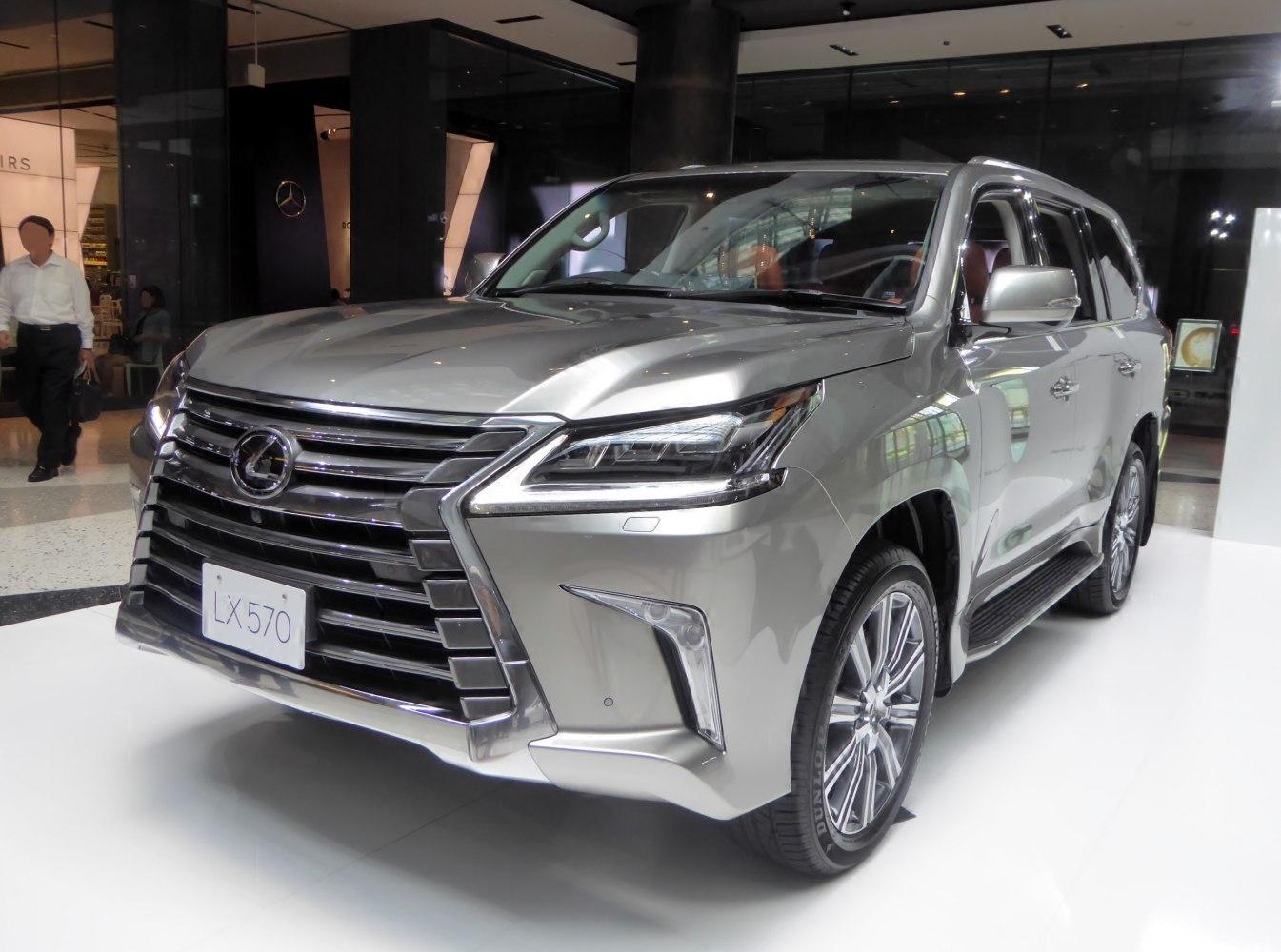 Front angle showing large spindle grille and LED headlights