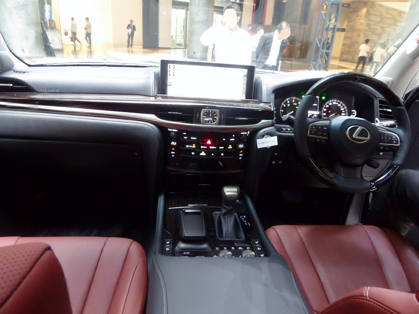Luxury SUV interior with wood trim, digital dashboard, and leather seats