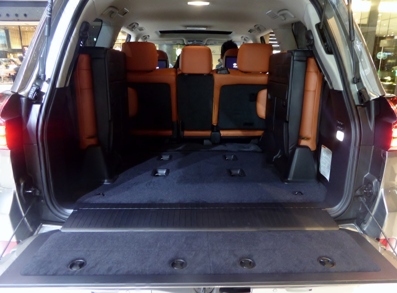 Spacious rear cargo area with folded third-row seats and premium leather upholstery