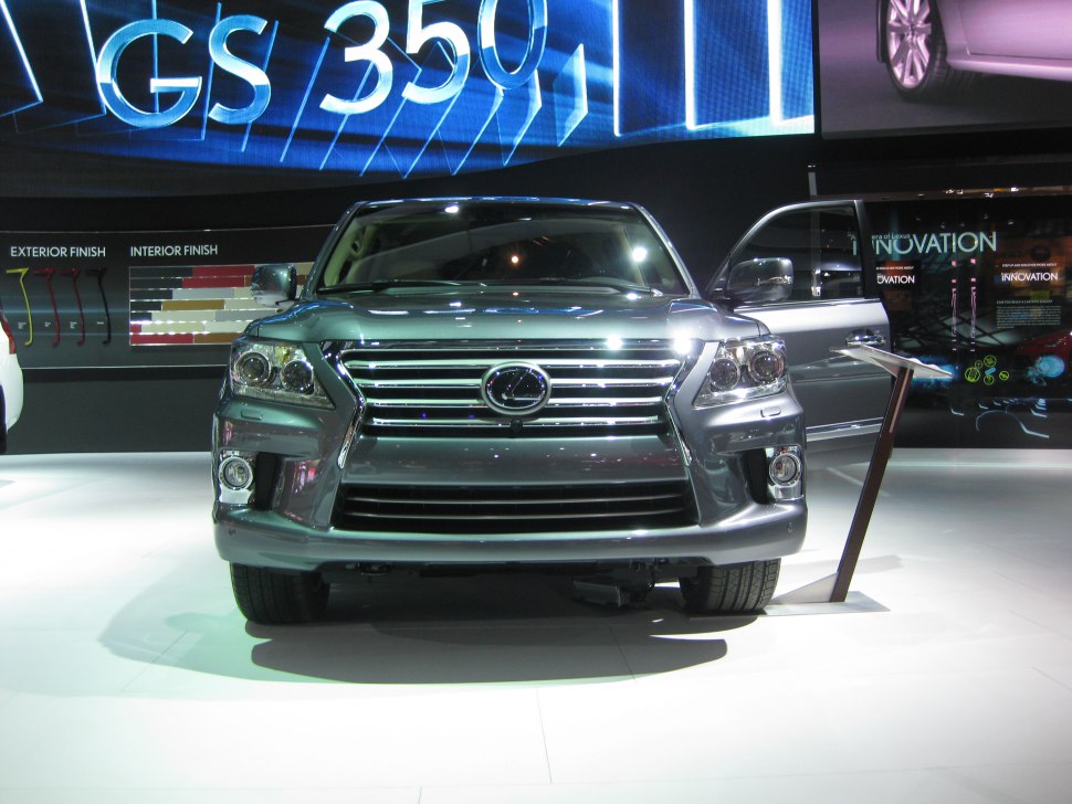 Front view of SUV with distinctive grille and headlights, open front door.
