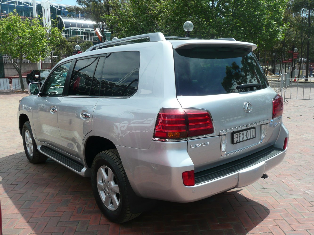 Silver luxury SUV rear and side with tinted windows and roof rails