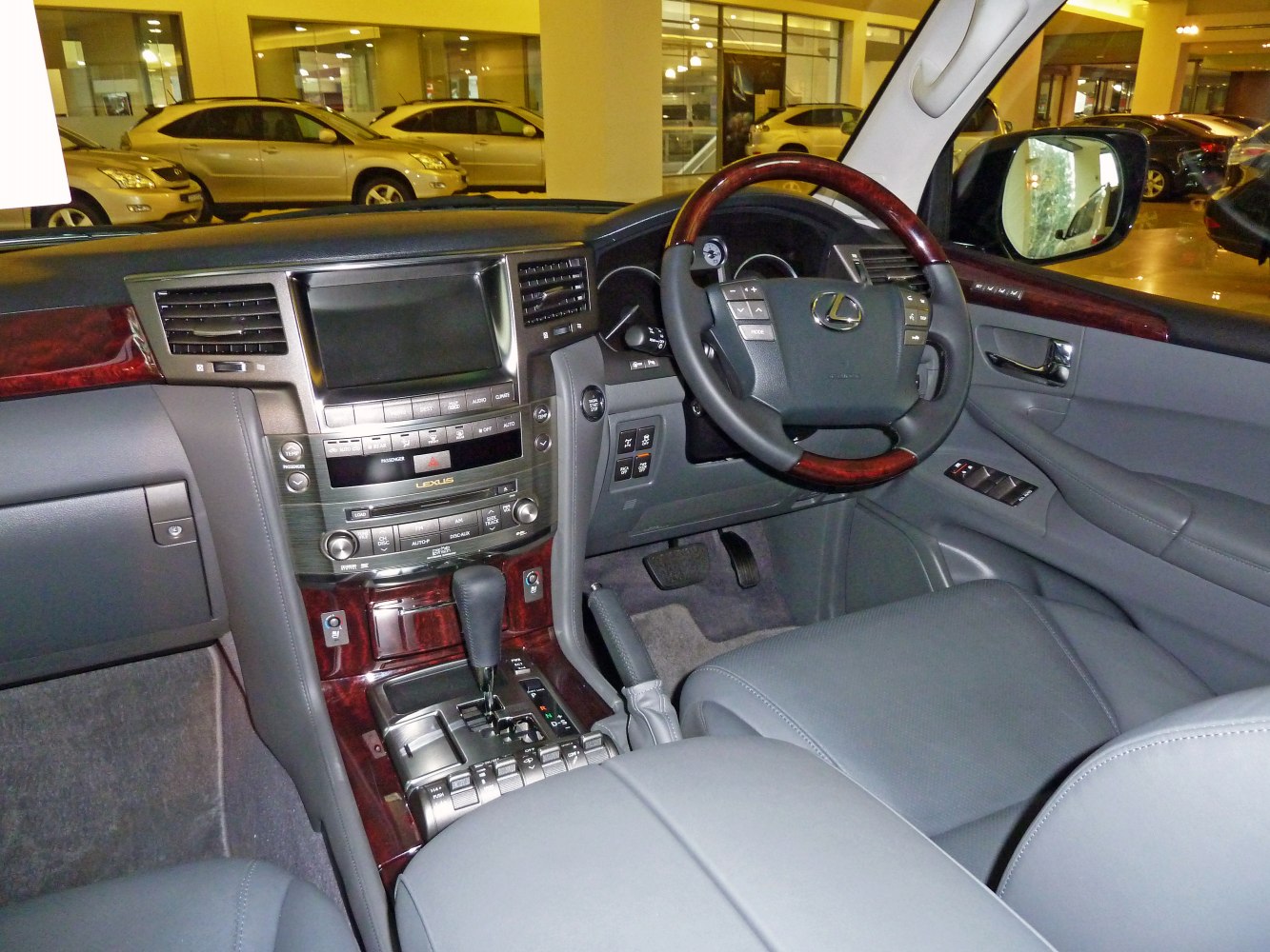 Luxury dashboard with wood-trimmed steering wheel and modern infotainment system