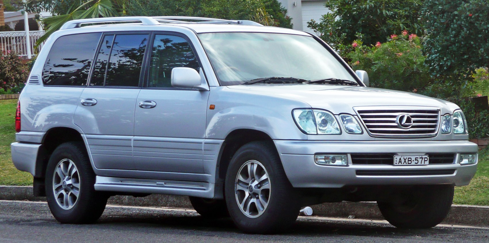 Front side view of luxury SUV with grille and headlight design