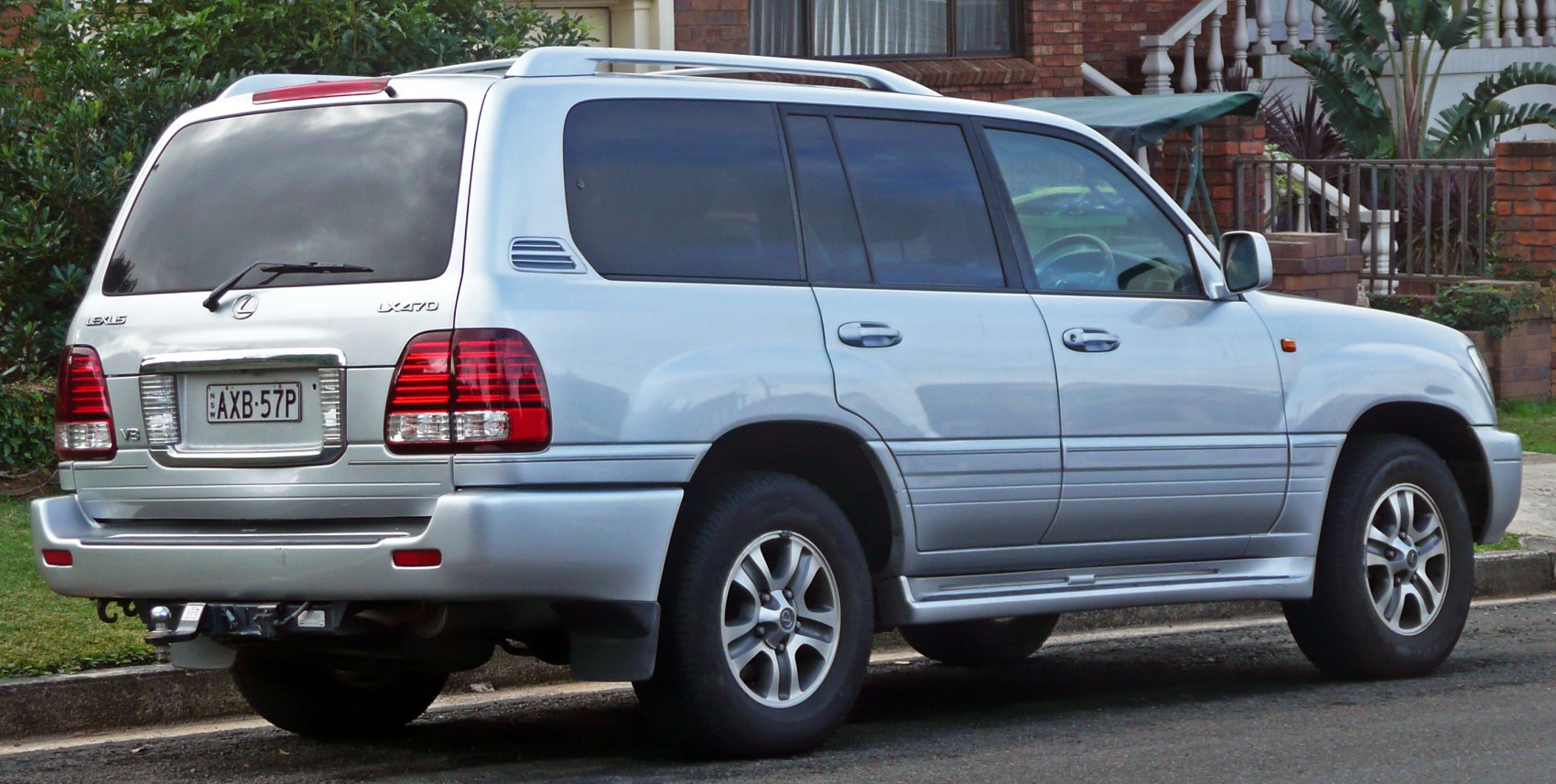 Silver SUV rear side view with roof rails and tinted windows