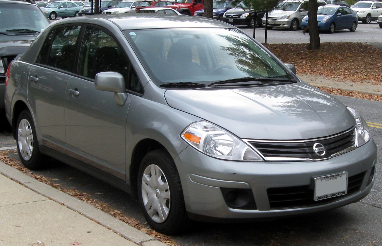Front and side view of a silver sedan with distinctive grille and headlights