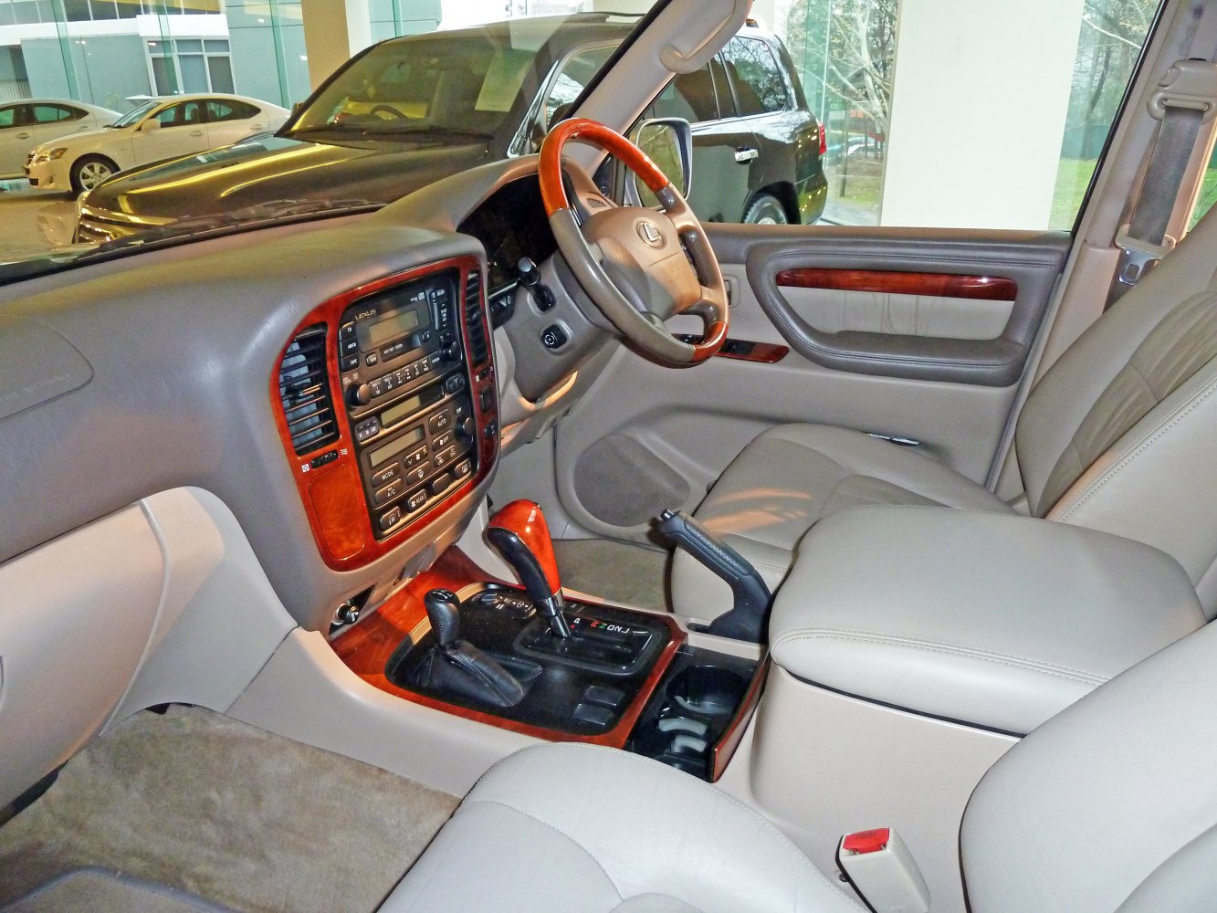Wood-trimmed dashboard with leather seats and dual gear levers