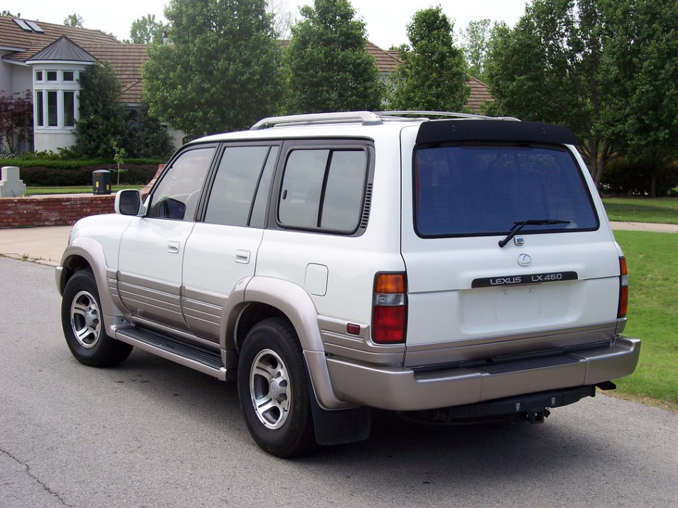 Rear and side of 1990s luxury SUV with tinted windows and robust design