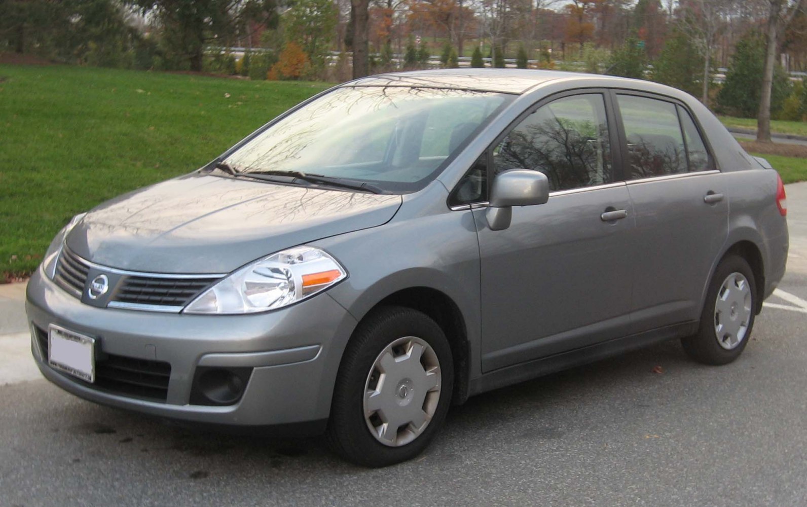 Compact sedan front side view with headlight and wheel details