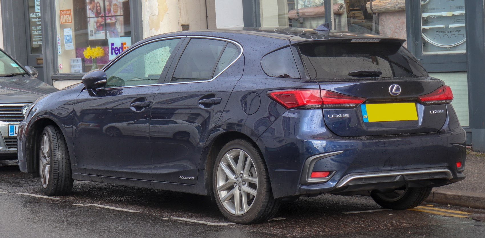 Rear and side view of a hatchback hybrid with hybrid badge