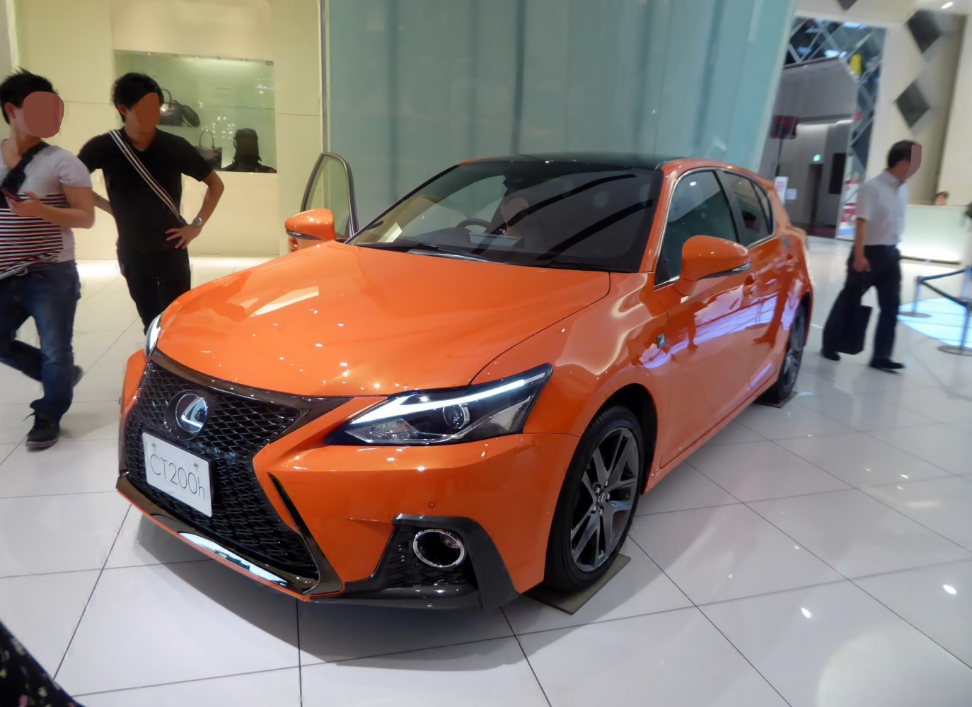 Bright orange car front with spindle grille and LED headlights