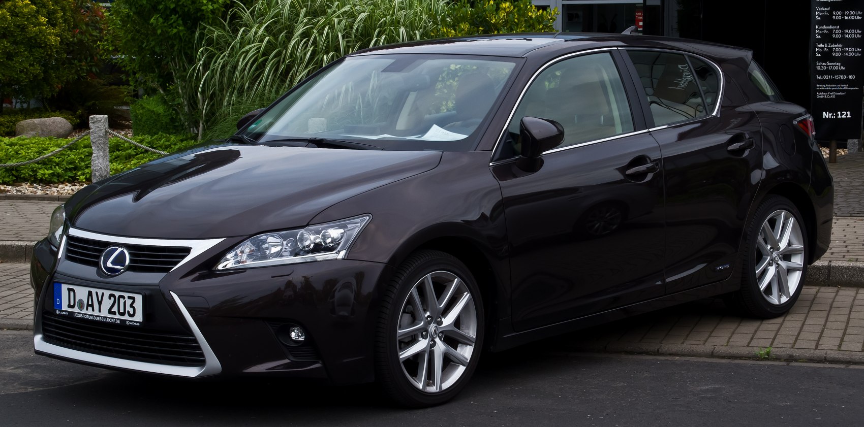 Front and side view of compact hatchback with chrome grille and alloy wheels