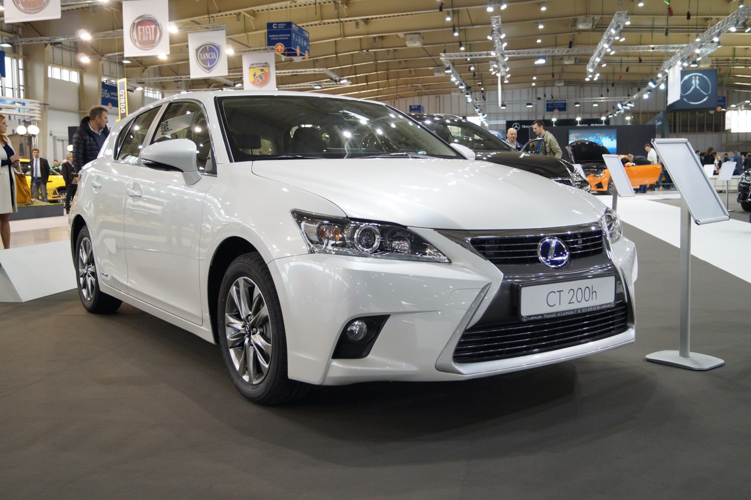 Front grille and headlight design of a hatchback with hybrid badge