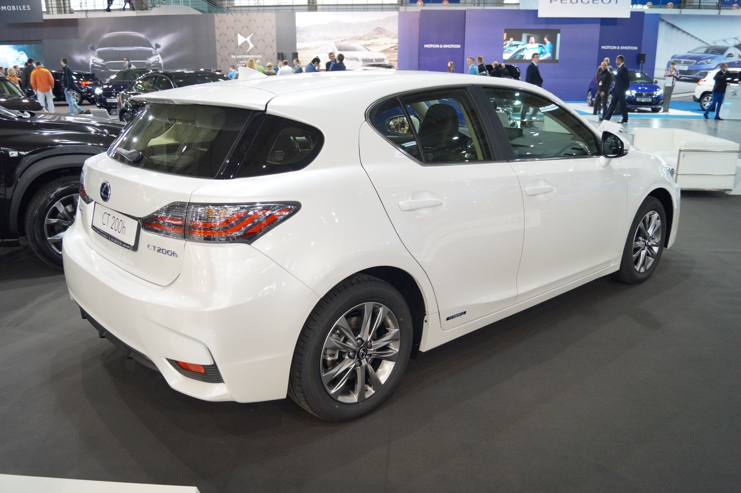 White hybrid hatchback rear and side with alloy wheels and taillights.